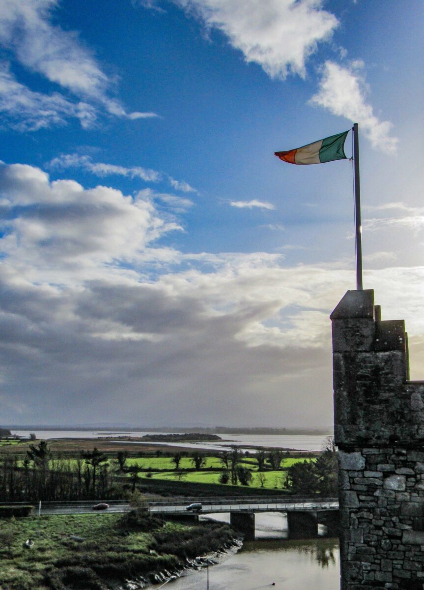 The Irish flag flies over Bunratty Castle in County Clare, Ireland