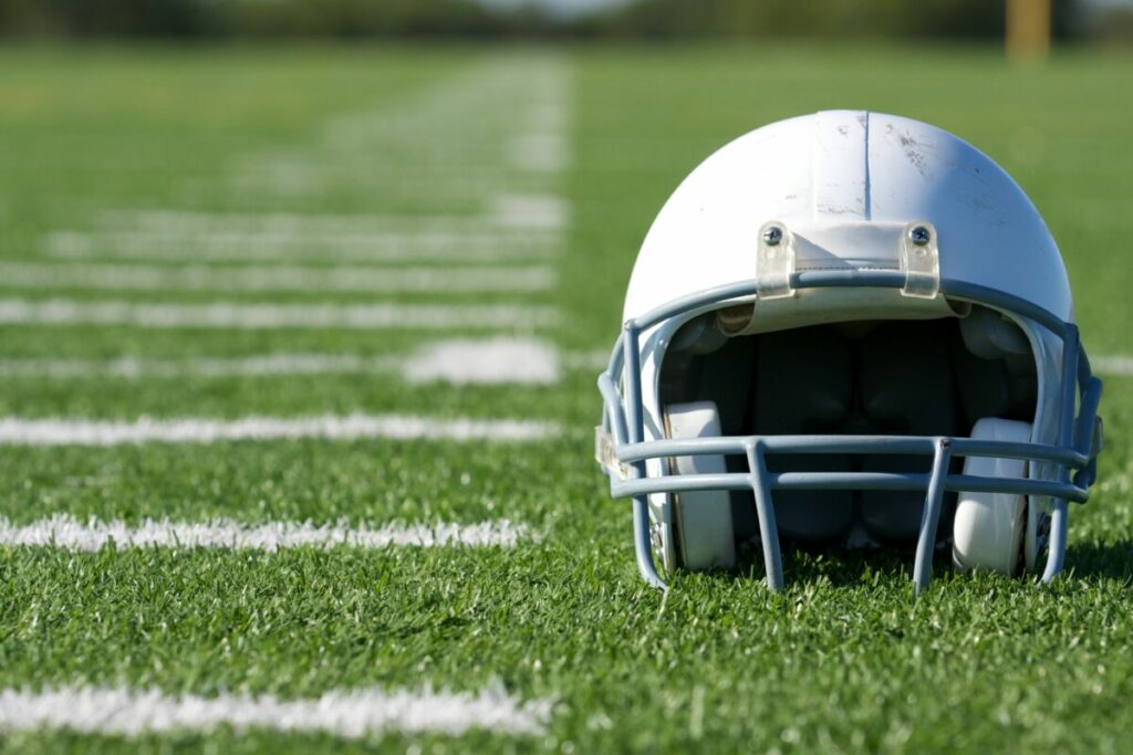 White football helmet on football field