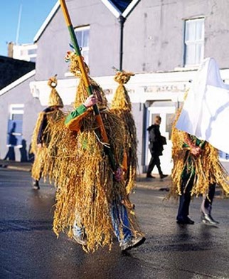People dressed in hay costumes referred to as wrenboys