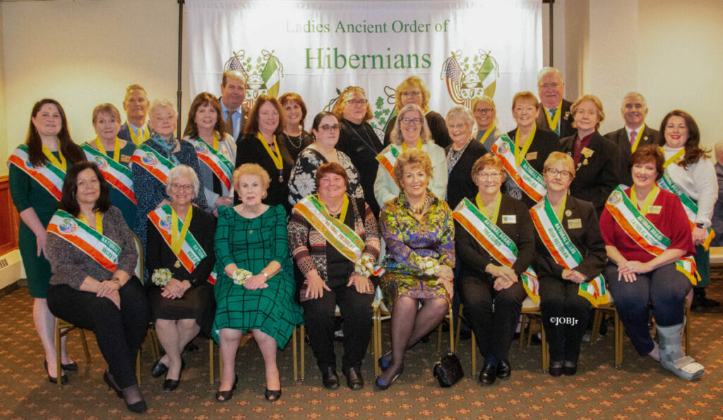 Picture of Ireland's Ambassador to the U.S. Geraldine Byrne Nason sitting with the Ladies Ancient Order of Hibernians